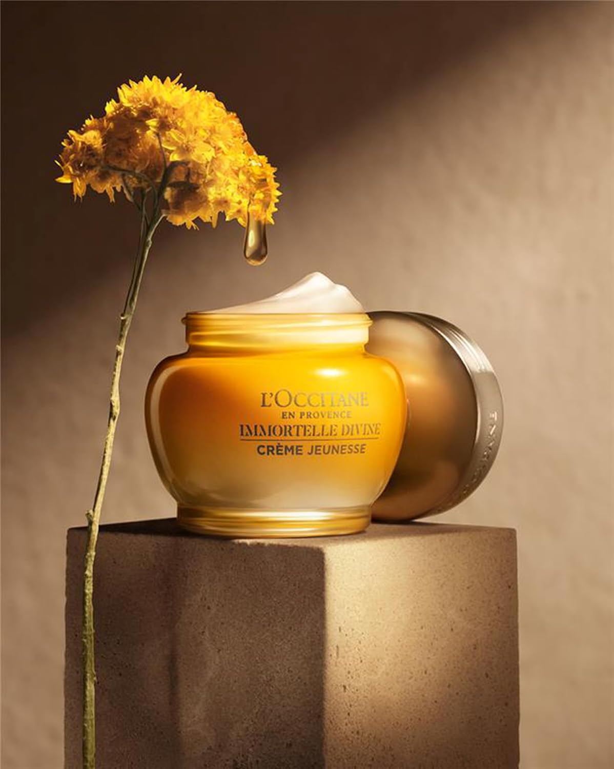 L'Occitane Immortelle Divine Cream luxury skincare product with gold packaging