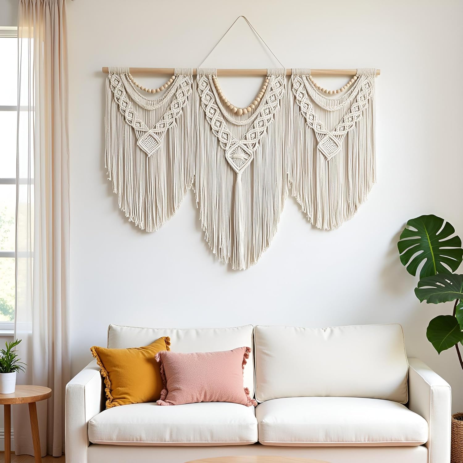 Full view of Achart large macrame wall hanging showing tassel length, wooden bead accents, and wooden dowel hanger